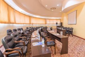 a conference room with long tables and chairs at Gold Crest Hotel - Arusha in Arusha +39 photos