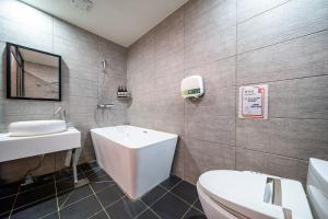 a bathroom with a toilet and a sink at No25 Hotel Yeonsan in Busan