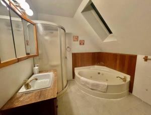 a bathroom with a large tub and a sink at Vancouver Castle Waterfront with hot tub beach downtown in Chemainus +80 photos