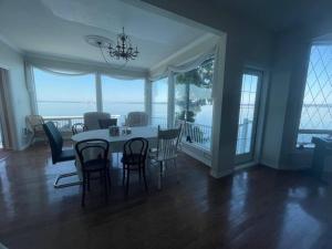 a dining room with a table and chairs with a view at Vancouver Castle Waterfront with hot tub beach downtown in Chemainus