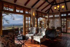 a living room with a couch and chairs at Lions Paw Ngorongoro in Ngorongoro