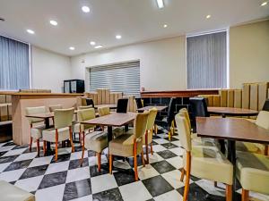 a dining room with tables and chairs at Weaste Hotel, West Manchester in Manchester