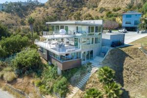 an aerial view of a house with a mountain at Malibu Glass House: Architectural w 180deg Views in Malibu