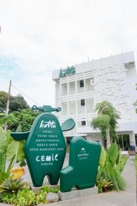 a sign in front of a building at Kotta Hotel Semarang in Semarang