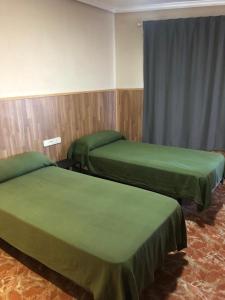 Voodi või voodid majutusasutuse Hotel Manises toas