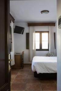 Postel nebo postele na pokoji v ubytování Hotel Tugasa Sierra y Cal