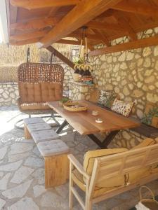 a wooden table and chairs on a patio at MARATHES STUDIOS in Agios Nikitas