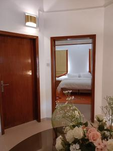 a room with a door and a bedroom with a bed at Peace Farm in Hatta