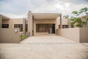 a large building with a driveway in front of it at Longhorn Executive Apartments in Lusaka