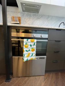 a kitchen with an oven with a towel on it at The Italian New Yorker in Sydney