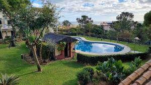an image of a swimming pool in a yard at Hoyo 12 Islantilla in Huelva