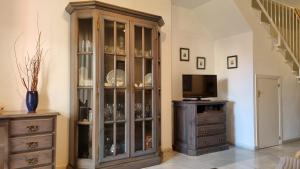 a large wooden china cabinet in a living room at Hoyo 12 Islantilla in Huelva