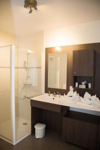 a bathroom with a sink and a shower at Domitys Le Phare d'Argent in Cherbourg en Cotentin