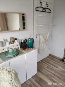 a kitchen with white cabinets and a counter top at gemütliches Einzelzimmer, nur Übernachtung, check in bis 0 Uhr in Brake Zwei