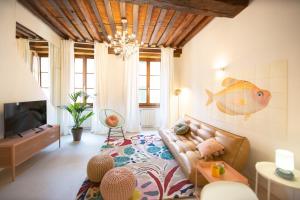a living room with a couch and a fish on the wall at La Corticella Luxury Suite, with Terrace in Lucca
