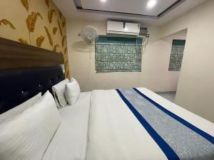 a bedroom with a large bed in a room at Hotel Baba - near Charbagh Railway Station in Lucknow