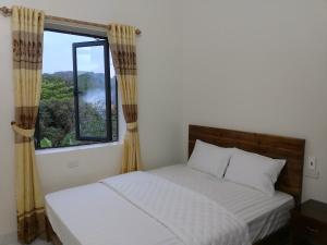 a bedroom with two beds and a window at Tuyet's hostel in Ninh Binh