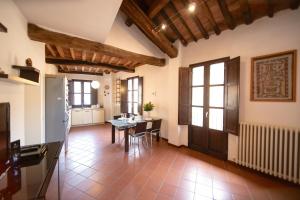 a kitchen and dining room with a table and chairs at Serena Apartment, Cosy Close Center Town in Lucca