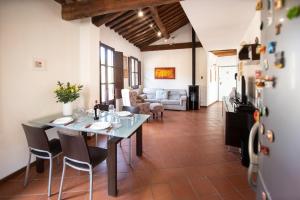 a kitchen and living room with a table and chairs at Serena Apartment, Cosy Close Center Town in Lucca