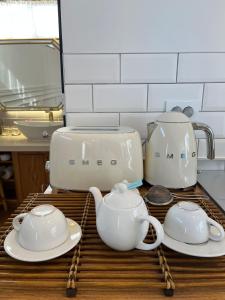 a counter with two tea pots and plates on it at That space Jeju in Jeju
