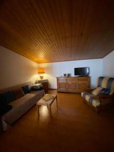 een woonkamer met een bank en een tafel bij Casa di borgo vista lago in Valsolda