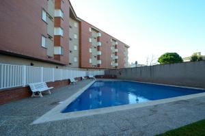 a swimming pool in front of a building at Terrassa del Mar 6-1-B in L'Escala