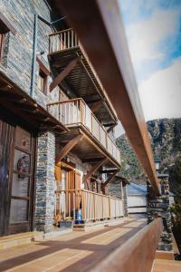 a house with wooden balconies on the side of it at Casa Samarra in Vall de Cardos