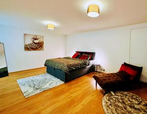 a bedroom with a bed and a couch in a room at Montreux lake side apartment! in Montreux