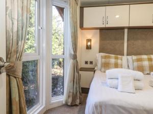 a bedroom with a bed and a large window at Hercules in Morpeth