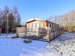 a cabin in the snow with a fence around it at Hercules in Morpeth