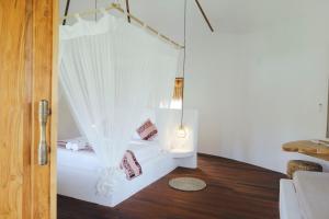Postel nebo postele na pokoji v ubytování Mana Eco Retreat