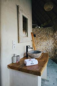 a bathroom with a sink on a wooden counter at Mana Eco Retreat in Kuta Lombok