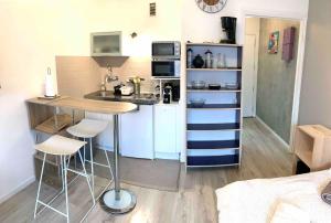 - une petite cuisine avec une table et des chaises dans la chambre dans l'établissement Studio LEON, à Chambéry