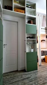 a white door in a room with a green closet at Incantevole appartamento a Torino! in Turin