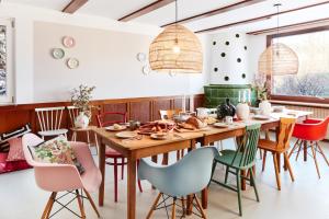 a dining room with a wooden table and chairs at pop-up stuub feldberg in Feldberg