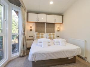 a bedroom with a bed with white sheets and pillows at Aquila in Morpeth