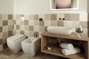 a bathroom with a sink and a toilet and a mirror at Villa Antica Dimora - Homelike Villas in Deruta +23 photos