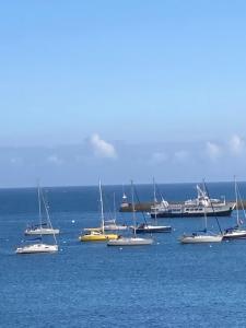 a group of boats sitting in the water at Maison Plogoff- Baie des Trépassées in Plogoff