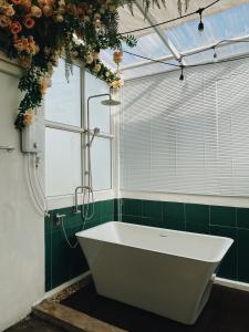 a bath tub in a bathroom with a window at Ceraclay Home in Nan