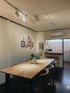 a large wooden table in a room with chairs at Ceraclay Home in Nan