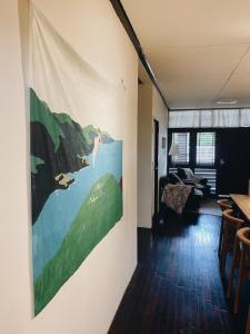 a living room with a large painting on the wall at Ceraclay Home in Nan