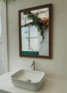 a sink in a bathroom with a mirror at Ceraclay Home in Nan