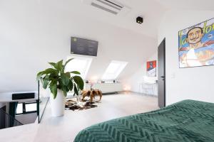 a bedroom with a bed and a tv on the wall at THE Penthouse at Eco Smart Apartments in Nürnberg