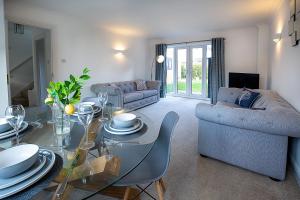 a living room with a table and a couch at Dragonfly House in Maidenhead