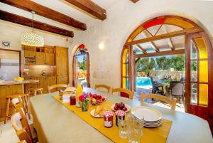 una cucina e una sala da pranzo con tavolo e sedie di Ta Gananz Holiday Home a Għasri