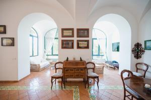 a living room with a table and chairs at Villa Tragara by Elite Villas in Capri