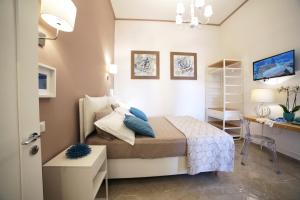 a small bedroom with a bed and a desk at Tenuta Cesarina in Alessano