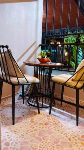 twee stoelen en een tafel in een kamer met een tafel bij 66 Apartment in Ban Khlong Nong Yai