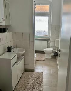 a white bathroom with a sink and a toilet at Apartment Zoey in Auerbach
