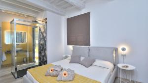 a bedroom with a bed with two towels on it at Ovile in Roccalbegna +30 photos